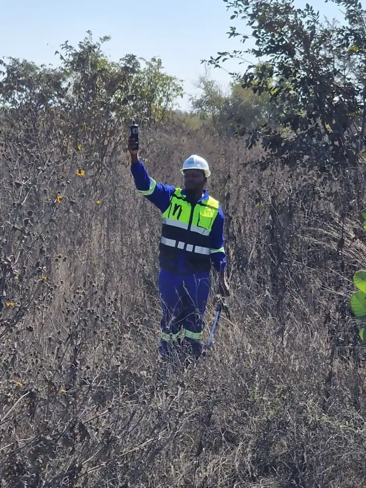 SunWise technician taking a baseline reading in an area of burnt scrub