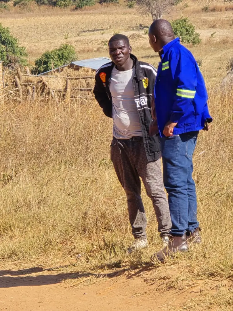 SunWise team member in company workwear in conversation with a resident on a rural path