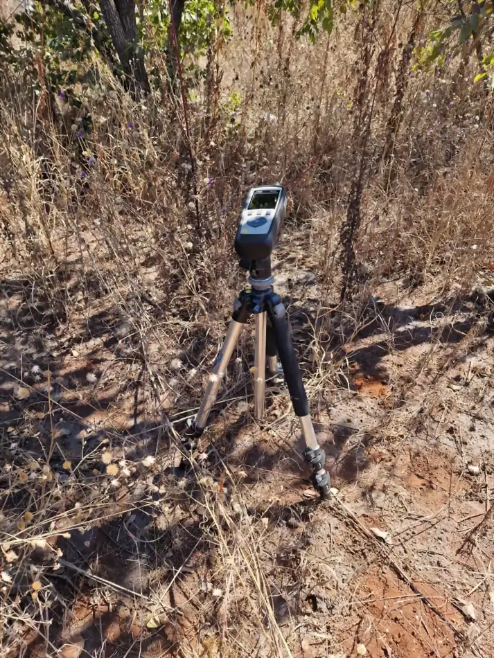 A tripod-mounted dust and air quality sampler deployed by SunWise in open ground for an ambient monitoring run