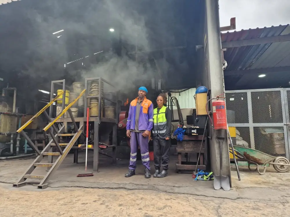 SunWise personnel in protective clothing inside a working manufacturing workshop during an industrial hygiene survey