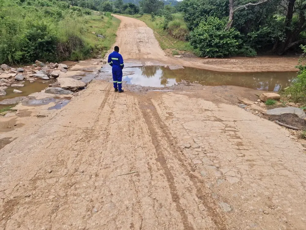 SunWise technician surveying a watercourse crossing on an unsurfaced access road